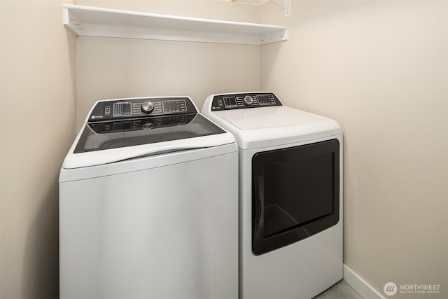 clothes washing area featuring laundry area and washing machine and dryer