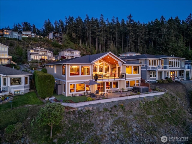 rear view of property with a patio area and a balcony