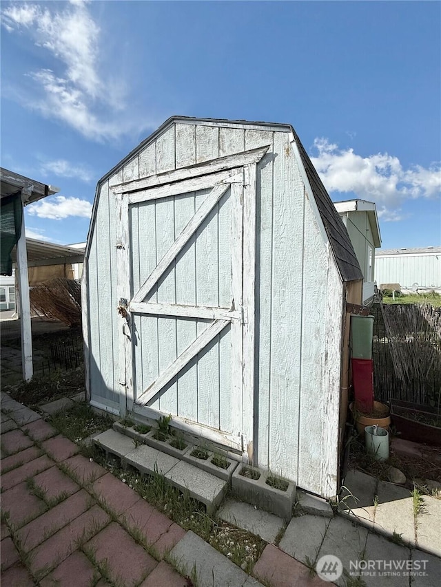 view of shed featuring fence