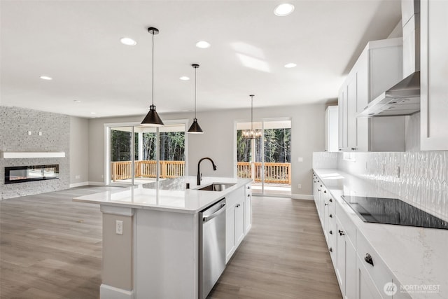 kitchen featuring dishwasher, black electric stovetop, recessed lighting, and a sink