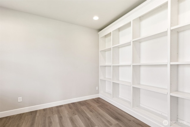 unfurnished room with baseboards, recessed lighting, and wood finished floors
