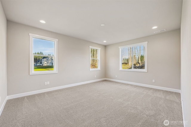 unfurnished room featuring baseboards, visible vents, carpet flooring, and recessed lighting