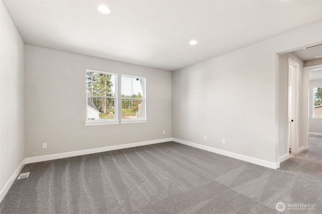 carpeted spare room featuring recessed lighting, visible vents, and baseboards