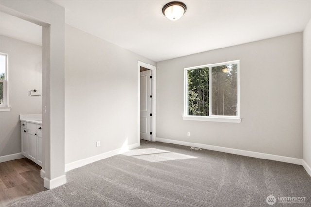 unfurnished bedroom with carpet and baseboards
