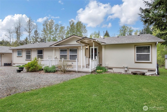 single story home with a porch, a shingled roof, and a front lawn