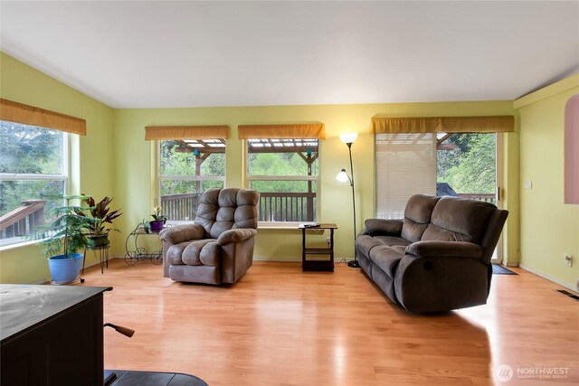 living room featuring baseboards and light wood finished floors