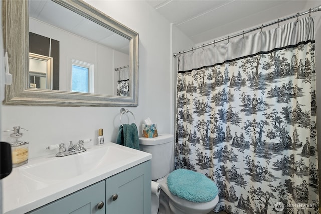 bathroom featuring toilet and vanity
