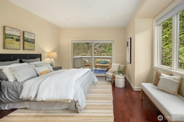 bedroom featuring baseboards, dark wood-style floors, and multiple windows