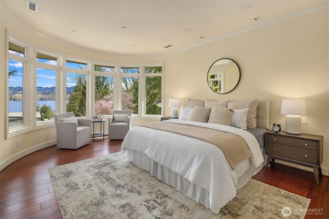 bedroom with crown molding, visible vents, dark wood-style flooring, and multiple windows