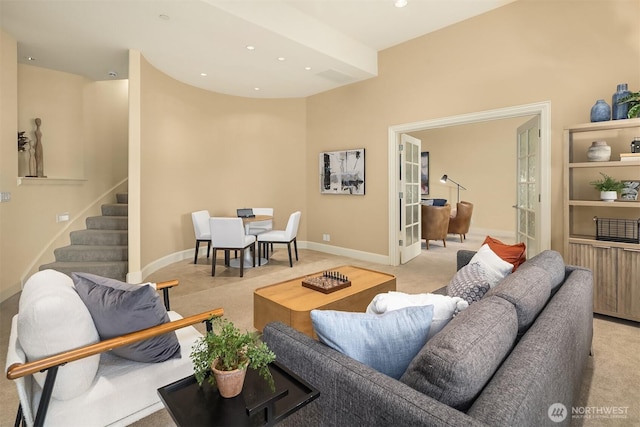 living room with recessed lighting, light carpet, and stairs