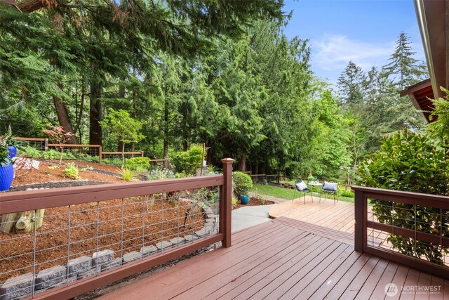 wooden terrace featuring fence