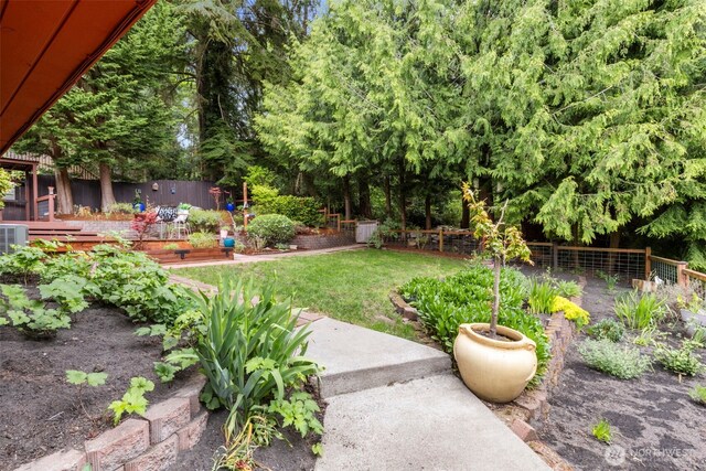 view of yard with fence and a vegetable garden