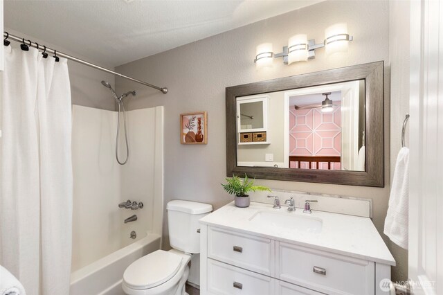 full bathroom with vanity, toilet, and shower / tub combo with curtain