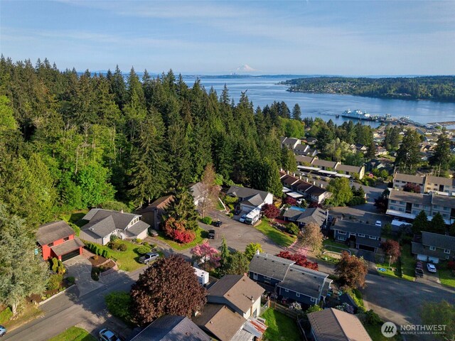 aerial view with a residential view, a water view, and a wooded view
