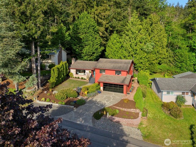 drone / aerial view with a wooded view