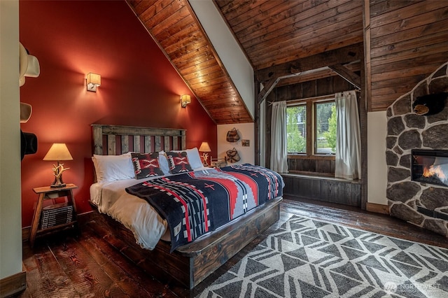 8105 Icicle Rd, Leavenworth, WA 98826 - bedroom with vaulted ceiling, baseboards, wood ceiling, hardwood / wood-style flooring, and a fireplace