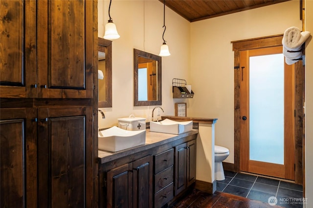 8105 Icicle Rd, Leavenworth, WA 98826 - full bath with double vanity, wood ceiling, toilet, and a sink