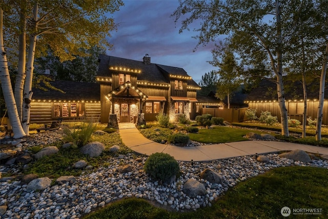 8105 Icicle Rd, Leavenworth, WA 98826 - rear view of house featuring stone siding, fence, a chimney, and board and batten siding