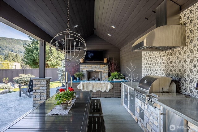 8105 Icicle Rd, Leavenworth, WA 98826 - view of patio / terrace featuring area for grilling, a grill, an outdoor stone fireplace, and fence