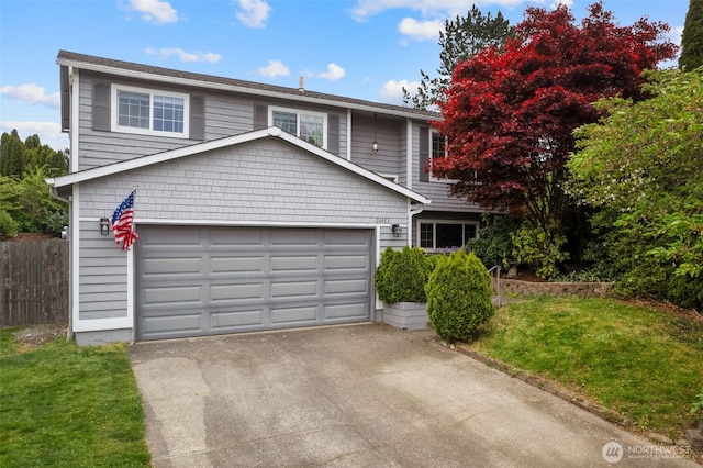 view of front facade featuring a garage, fence, and driveway