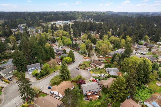 bird's eye view with a wooded view and a residential view