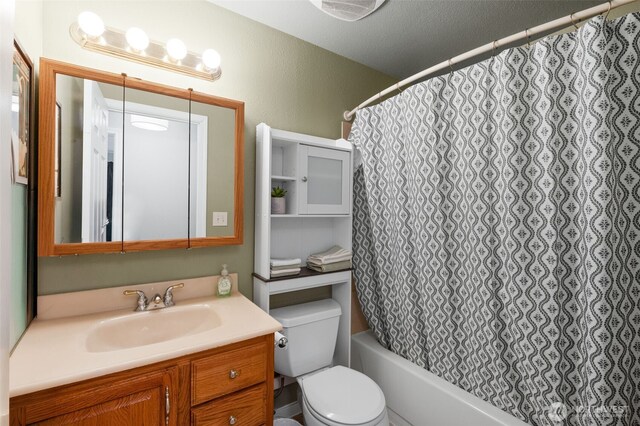 full bath featuring vanity, toilet, and shower / tub combo