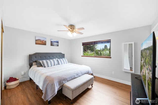 bedroom featuring baseboards, a ceiling fan, and wood finished floors