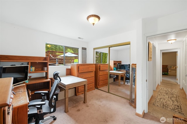 home office with light carpet and visible vents