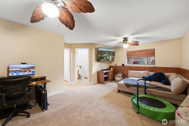 carpeted living room featuring a textured ceiling and ceiling fan
