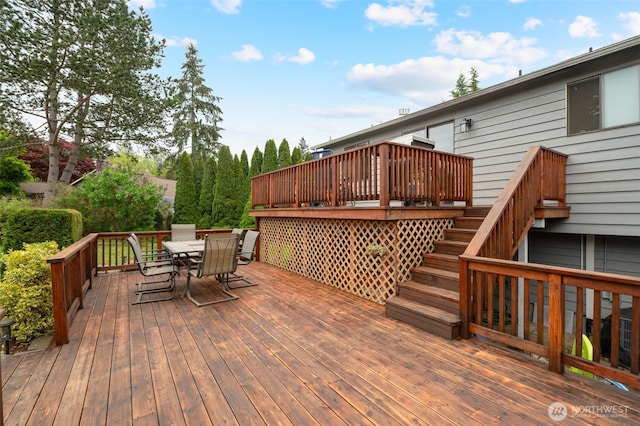 deck with outdoor dining space and stairs