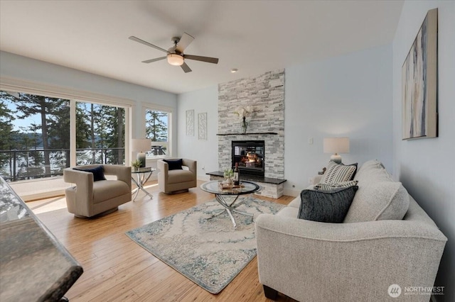 1447 Everette Ln, Freeland, WA 98249 - living room with a ceiling fan, wood finished floors, and a fireplace