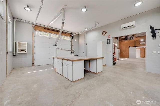 1447 Everette Ln, Freeland, WA 98249 - basement featuring a barn door, a wall mounted air conditioner, and a garage