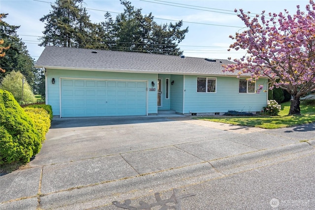 single story home featuring driveway, a shingled roof, and an attached garage