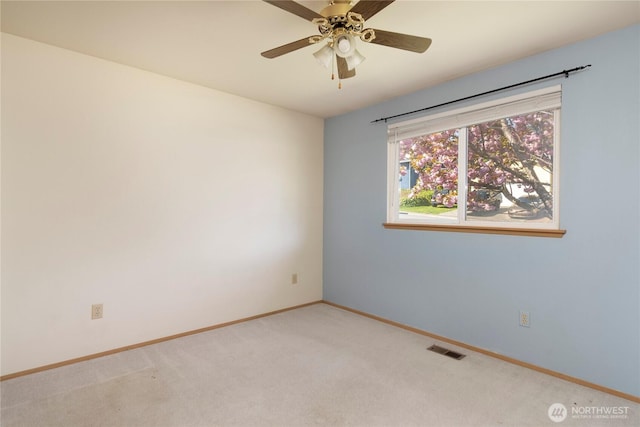 empty room featuring visible vents, ceiling fan, light carpet, and baseboards