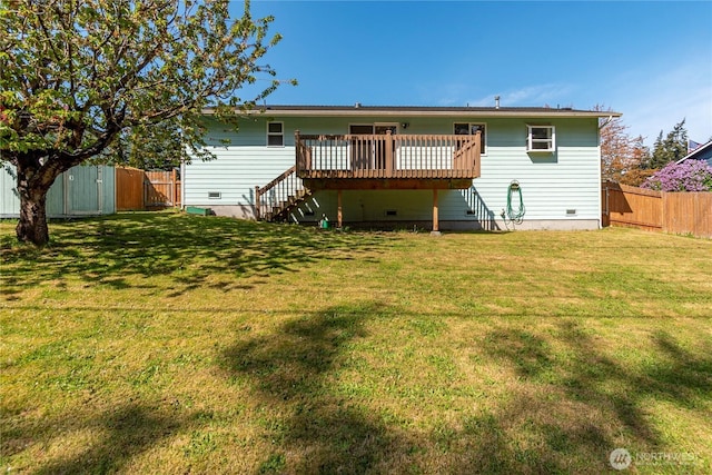 back of house with a fenced backyard, a gate, a lawn, stairs, and a deck