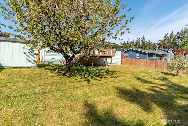 view of yard featuring a deck and fence