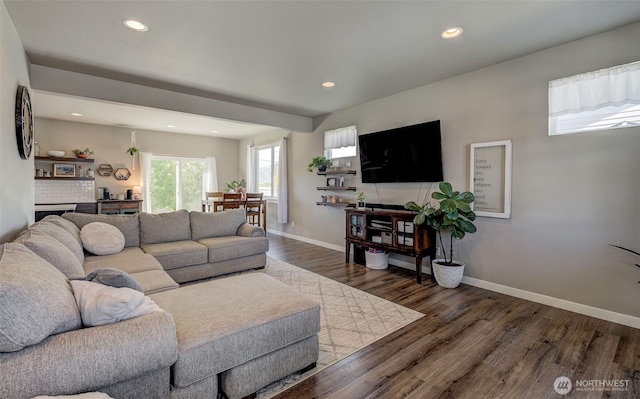 living room featuring baseboards, recessed lighting, and wood finished floors
