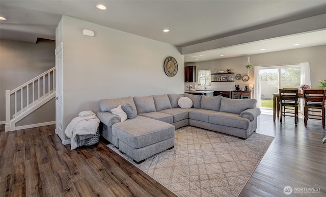 living area featuring stairs, recessed lighting, and wood finished floors