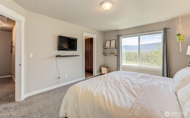 carpeted bedroom with baseboards and visible vents