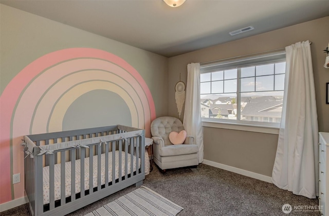 carpeted bedroom featuring baseboards, visible vents, and a crib