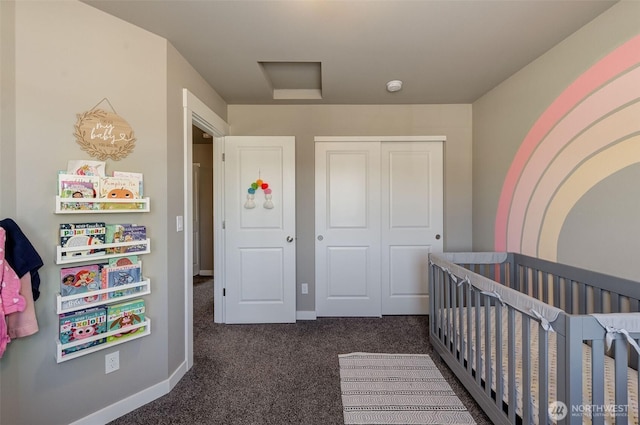 carpeted bedroom with a nursery area, attic access, and a closet