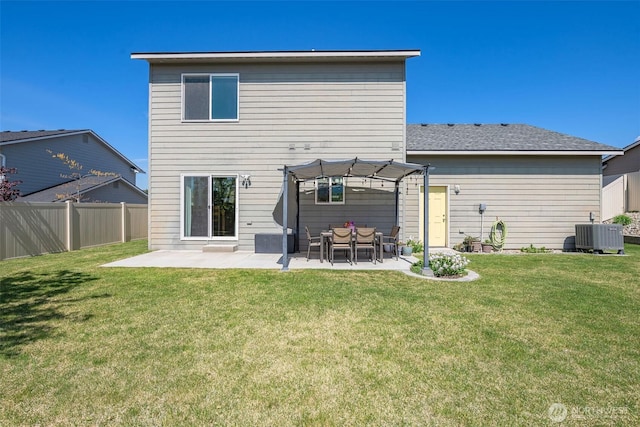 back of property with central air condition unit, a patio, fence, a yard, and a pergola
