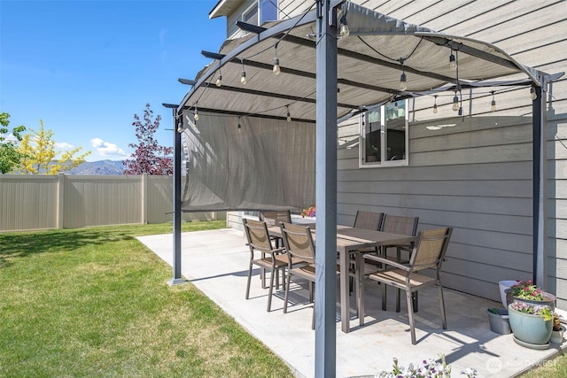 view of patio / terrace with fence, a pergola, and a mountain view