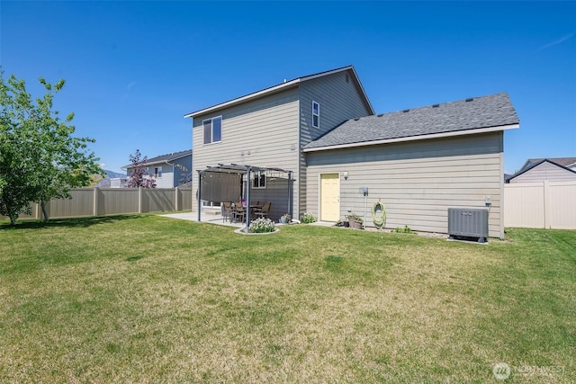 rear view of house featuring a fenced backyard, a patio, a lawn, and a pergola