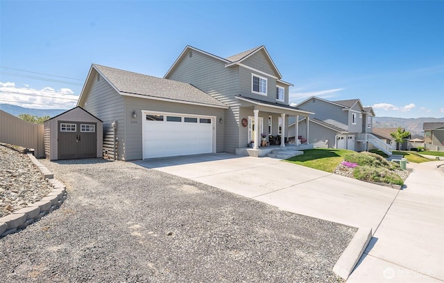 view of front of house with covered porch, an outbuilding, a storage unit, concrete driveway, and an attached garage
