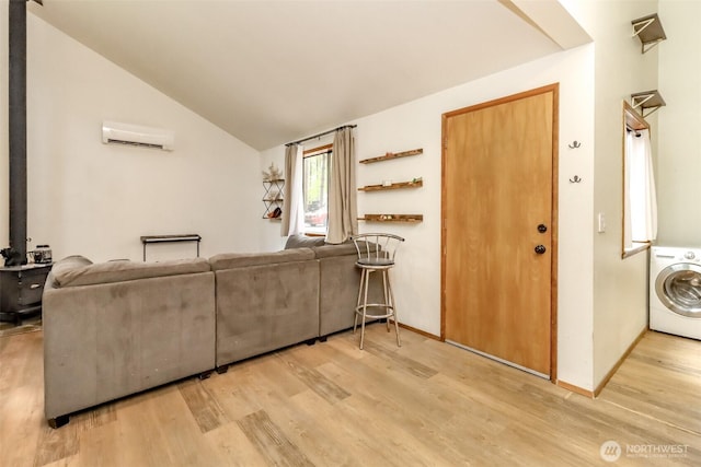 17936 Clearland Blvd SE, Yelm, WA 98597 - living area with washer / dryer, wood finished floors, an AC wall unit, and vaulted ceiling