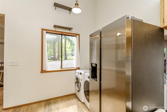 17936 Clearland Blvd SE, Yelm, WA 98597 - washroom featuring washing machine and dryer, light wood finished floors, baseboards, and a towering ceiling