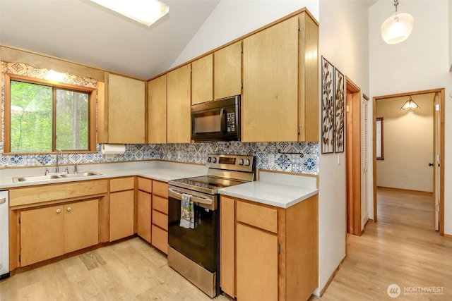 17936 Clearland Blvd SE, Yelm, WA 98597 - kitchen with stainless steel range with electric cooktop, black microwave, a sink, light wood-style floors, and high vaulted ceiling