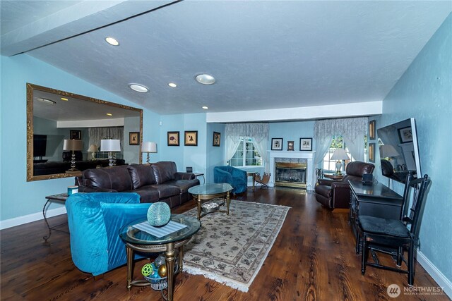 living room with recessed lighting, a high end fireplace, wood finished floors, and vaulted ceiling
