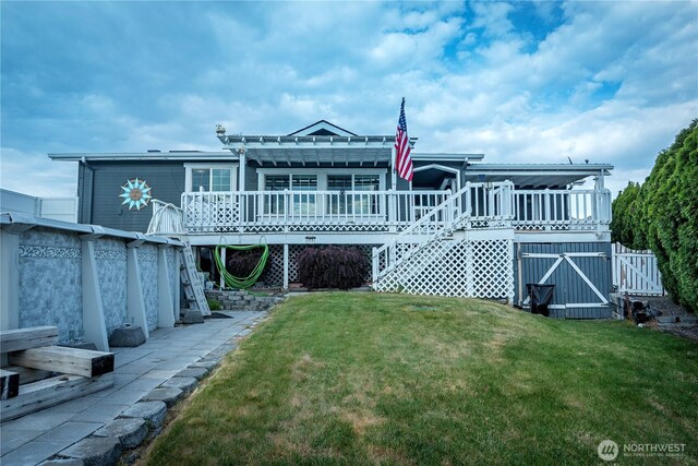 back of house with a lawn and a wooden deck